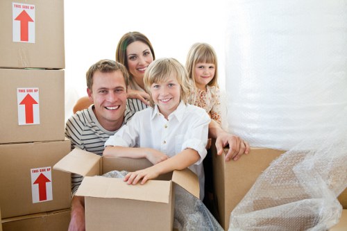 Packed moving boxes and protected furniture ready for transport