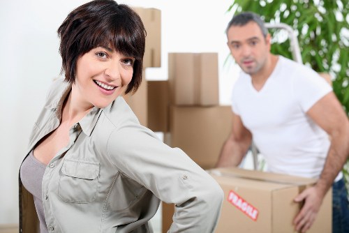 Professional movers handling household items in an East London property